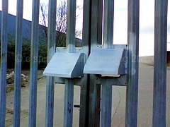 Padlock cover hoods fitted to existing entrance gates