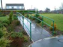 Green powder coated hand rails formed from powder coated galvanised steel tube and tubular clamp connectors
