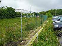 1800mm high green PVC chain link fencing supported on galvanised angle steel fence posts