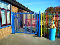 Blue powder coated bow top vertical bar access gate - designed with minimal protruding steel work for a school play area