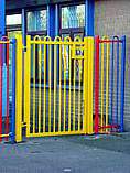 Yellow powder coated bow top vertical bar access gate - designed with minimal protruding steel work for a school play area