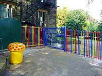 Blue powder coated bow top vertical bar access gate - designed with minimal protruding steel work for a school play area