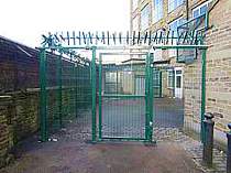 Green powder coated access gate in-filled with 358 mesh and complete with overhead rotating spikes - Gate secured with twin magnetic locks 