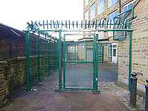 Green powder coated access gate in-filled with 358 mesh and complete with overhead rotating spikes - Gate secured with twin magnetic locks 
