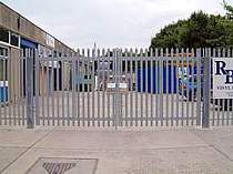 Galvanised palisade entrance gates with padlock cover hoods