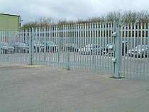 Large 6000mm wide single leaf gate incorporating 1 sliding padlock lock bar and 2 additional fixed padlock bars# all complete with padlock cover hoods and a central removable bollard