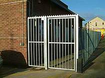 Galvanised vertical bar access gate - top of gate protected with a serrated steel top