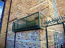 Green powder coated anti-climb cage to protect the building roof at a special needs school - cage in-filled with 358 welded mesh panels