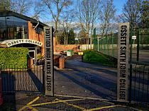 Laser cut stainless steel entrance signs fixed to a black powder coated support frame - the black powder coating on the support frame provides a high contrast to the sign's cut-out lettering