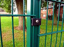 Green powder coated 868 mesh panel fencing - close up of the mesh connecting clips