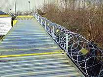 710mm dia. concertina razor wire fixed to the top of some storage containers