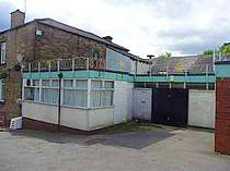 Flat wrapped razor wire supported on galvanised angle steel brackets