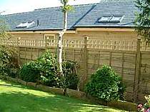 Heavy duty wood panel fence with additional top trellis panel